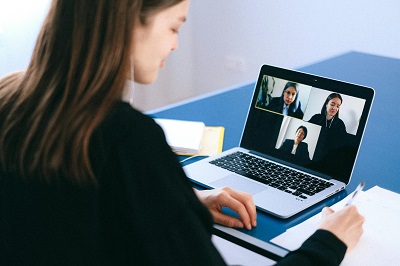 Woman with laptop in an online meeting