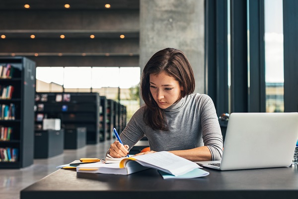 Woman working at a desk in a library
